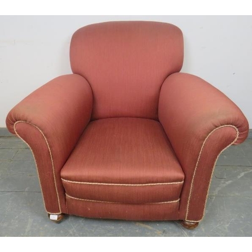 743 - An Edwardian club armchair, re-upholstered in light burgundy material with silver braided rope trim,... 