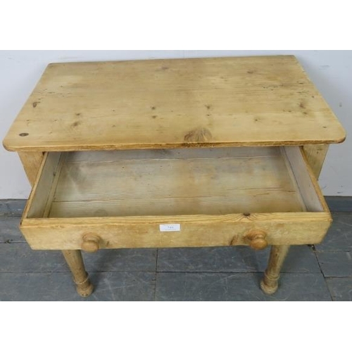 749 - An antique stripped pine side table, housing one long drawer with turned wooden handles, on tapering... 