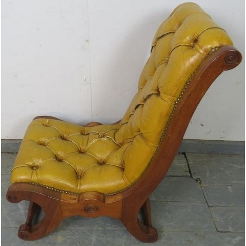 750 - A reproduction mahogany slipper chair, upholstered in buttoned mustard leather with brass studs, on ... 