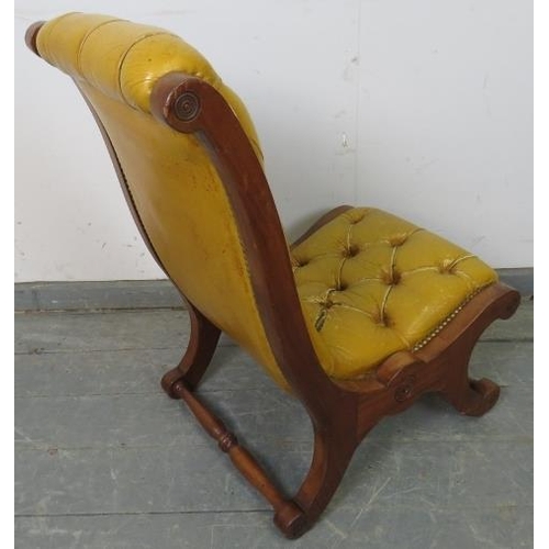 750 - A reproduction mahogany slipper chair, upholstered in buttoned mustard leather with brass studs, on ... 