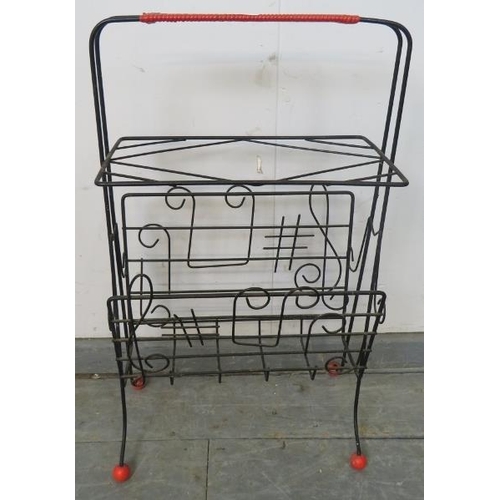 760 - A mid-century wirework atomic style ‘sputnik’ magazine rack, the sides with depictions of musical no... 