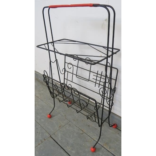 760 - A mid-century wirework atomic style ‘sputnik’ magazine rack, the sides with depictions of musical no... 