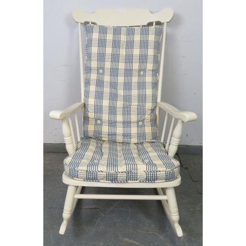 763 - An American style rocking chair painted white, with sprung seat and loose seat squab cushion upholst... 