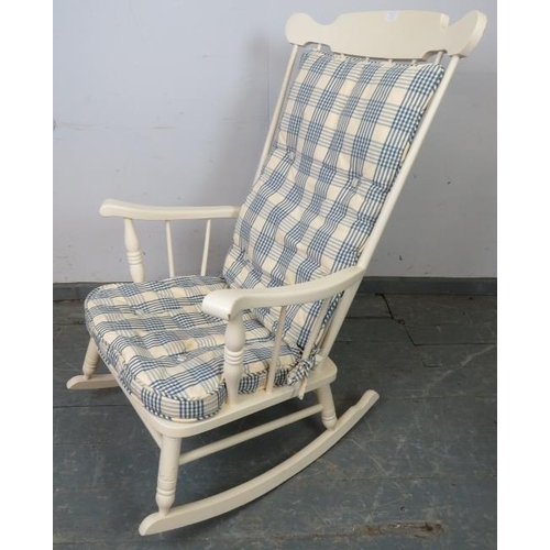 763 - An American style rocking chair painted white, with sprung seat and loose seat squab cushion upholst... 