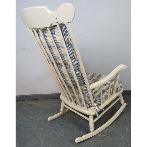 763 - An American style rocking chair painted white, with sprung seat and loose seat squab cushion upholst... 