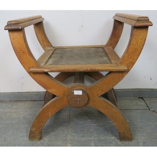 764 - An Arts & Crafts limed oak ‘X-frame’ stool with armrests, on curved supports with side stretchers.
H... 