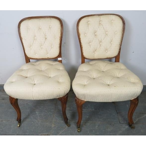 765 - A pair of antique French oak occasional chairs, upholstered in buttoned cream material, on cabriole ... 