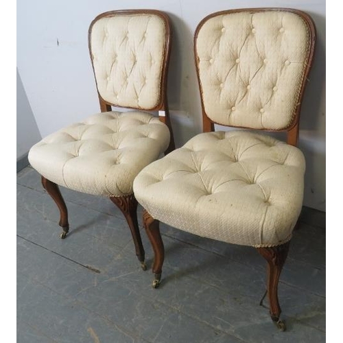 765 - A pair of antique French oak occasional chairs, upholstered in buttoned cream material, on cabriole ... 