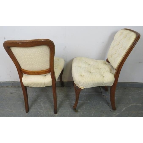 765 - A pair of antique French oak occasional chairs, upholstered in buttoned cream material, on cabriole ... 