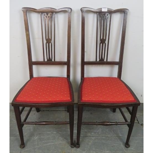 766 - A pair of Edwardian mahogany side chairs, strung with satinwood, the seats upholstered with scarlet ... 