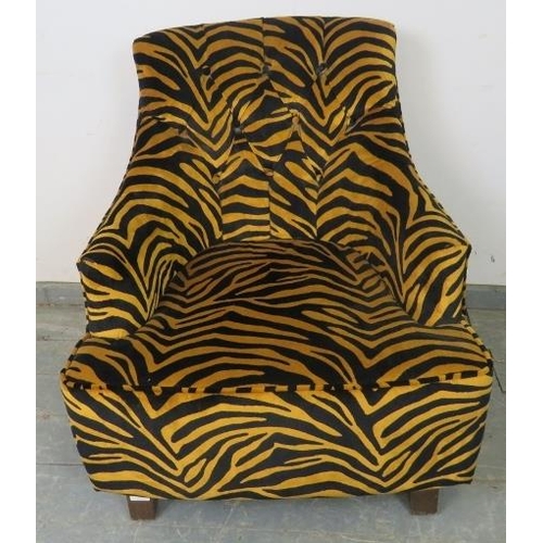 767 - A contemporary armchair, upholstered in buttoned tiger print velvet type material, on tapering squar... 