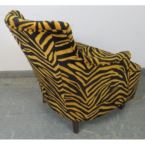 767 - A contemporary armchair, upholstered in buttoned tiger print velvet type material, on tapering squar... 