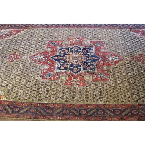 922 - A superb Persian carpet, central motif on a latticework ground with quarter spandrels. 317cm x 152cm... 