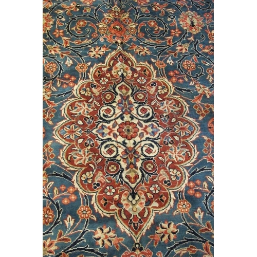 923 - A fine Persian Kashan carpet, central terracotta motif on blue ground. 420cm x 290cm.
Condition repo... 