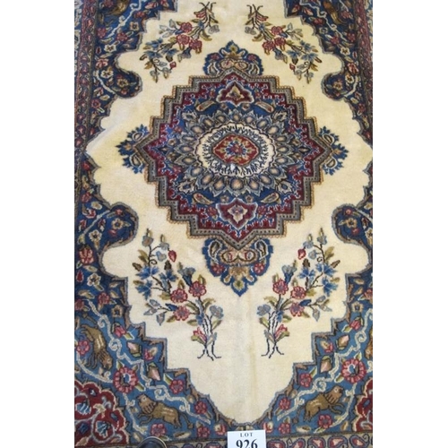 926 - A Persian rug with a central motif, on cream ground and a blue wide border with signature, see image... 