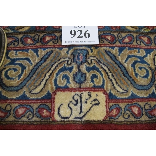 926 - A Persian rug with a central motif, on cream ground and a blue wide border with signature, see image... 