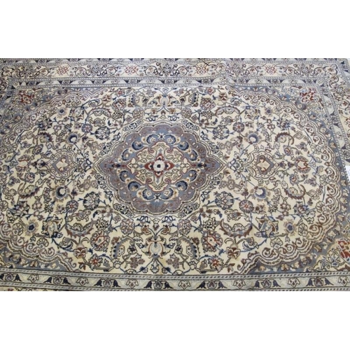 929 - A fine Persian Nain carpet, pale blue central motif on a highly patterned cream ground. 288cm x 200c... 