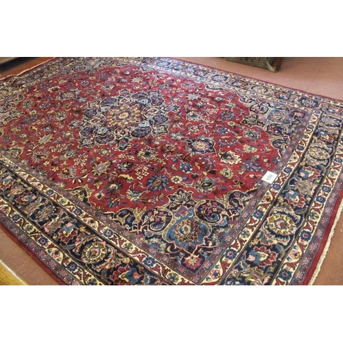 930 - A superb Persian Meshed carpet, central motif, blue on red ground with flowers and foliage. 345cm x ... 