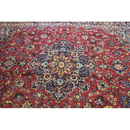 930 - A superb Persian Meshed carpet, central motif, blue on red ground with flowers and foliage. 345cm x ... 