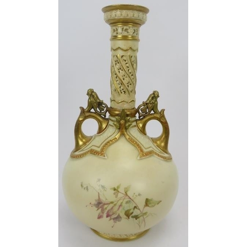 252 - A large Royal Worcester twin handled vase. With a pierced cylindrical neck, gilt handles and highlig... 