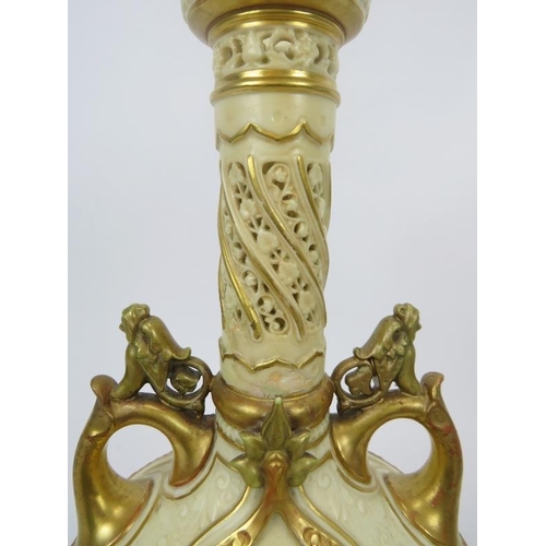 252 - A large Royal Worcester twin handled vase. With a pierced cylindrical neck, gilt handles and highlig... 