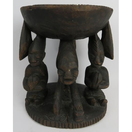 261 - Tribal Art: A Kola nut carved wood offering stand, Yoruba Tribe. Carved depicting three figures supp... 