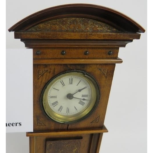 266 - Miniature long case clock, walnut, traces of gilding to etched panel, not tested, 18cm height. 
Cond... 