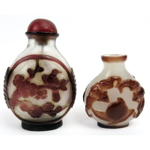 102 - Two Chinese overlay glass snuff bottles, late 19th/early 20th century. Both of ovoid form with ruby ... 