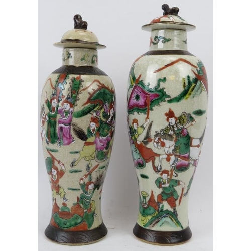 115 - Two Chinese Nanking famille verte crackle glaze vases and covers. Overglaze painted with continuous ... 