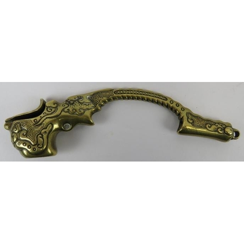 122 - A Chinese brass opium pipe, 19th century. Modelled with a scaled dragon grip handle, suspension ring... 