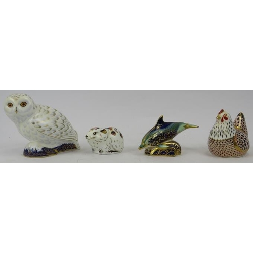 138 - A group of four Royal Crown Derby porcelain figurines. Comprising a snowy owl, bank vole, baby bottl... 