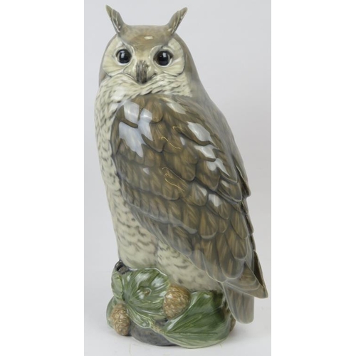 140 - A large Royal Copenhagen model of a long eared owl. Modelled on a naturalistic base with pine cones.... 