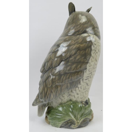 140 - A large Royal Copenhagen model of a long eared owl. Modelled on a naturalistic base with pine cones.... 