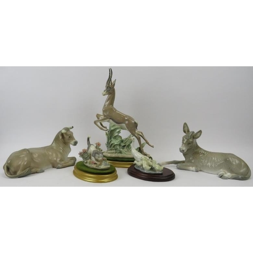 141 - A group of five Lladro figurines. Comprising a leaping gazelle, recumbent bull, recumbent donkey, go... 