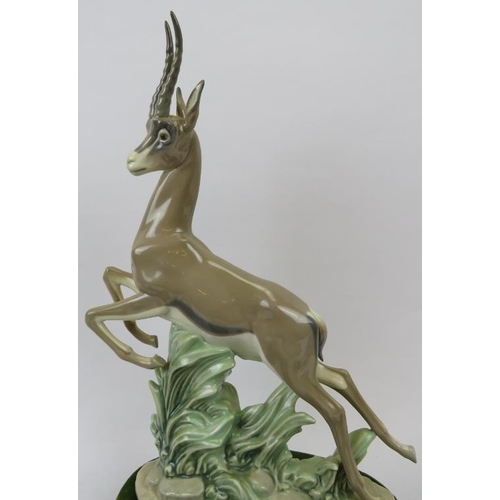 141 - A group of five Lladro figurines. Comprising a leaping gazelle, recumbent bull, recumbent donkey, go... 