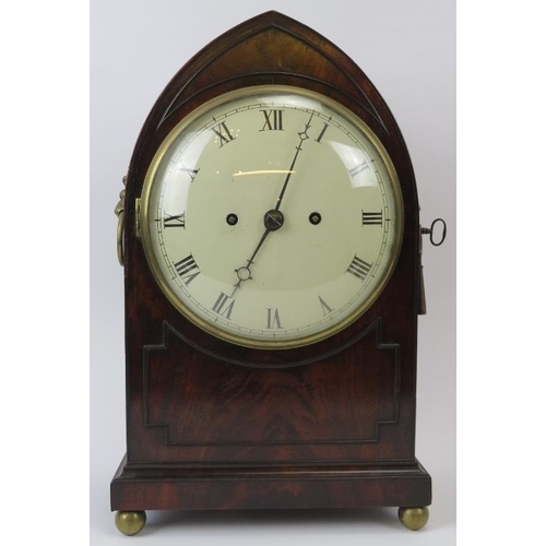 15 - A Regency mahogany clock, 19th century. The mahogany case of gothic form with lion mask handles, ena... 