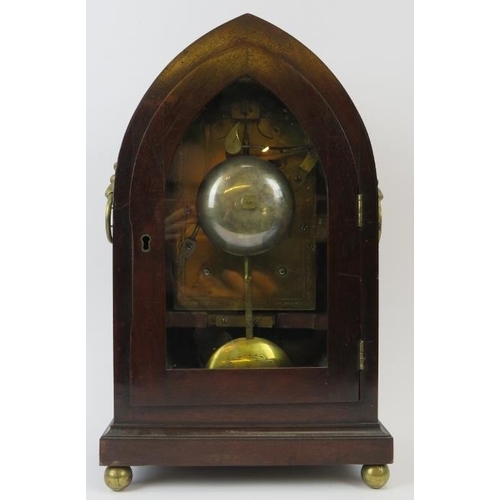 15 - A Regency mahogany clock, 19th century. The mahogany case of gothic form with lion mask handles, ena... 