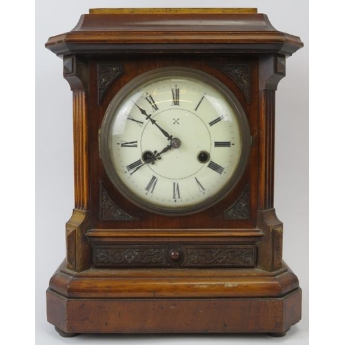 16 - A Victorian mahogany table clock, 19th century. With enamelled Roman numeral dial and supported on b... 