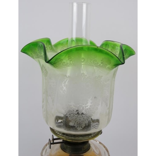 166 - A large Victorian brass and coloured glass oil lamp. Supported on a ceramic base. 22 in (56 cm) widt... 