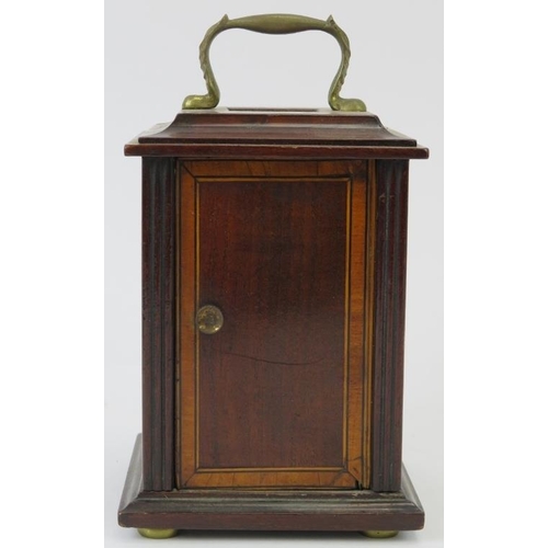 21 - An Edwardian mahogany carriage clock. With a bevelled glass front and enamelled Roman numeral dial. ... 