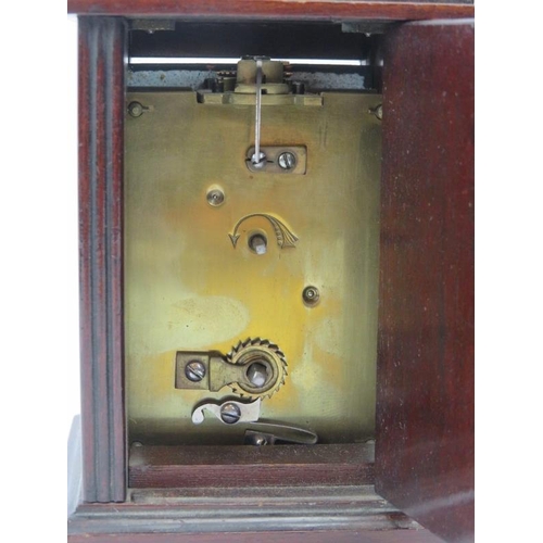 21 - An Edwardian mahogany carriage clock. With a bevelled glass front and enamelled Roman numeral dial. ... 