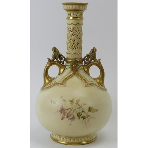 252 - A large Royal Worcester twin handled vase. With a pierced cylindrical neck, gilt handles and highlig... 