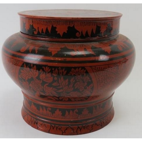 264 - A large Indo Persian red lacquered covered pot. Of baluster form with black hand painted decoration.... 