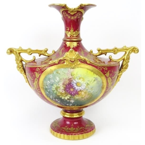 3 - A European twin handled floral and gilt decorated vase, 19th century. Probably German manufactured. ... 