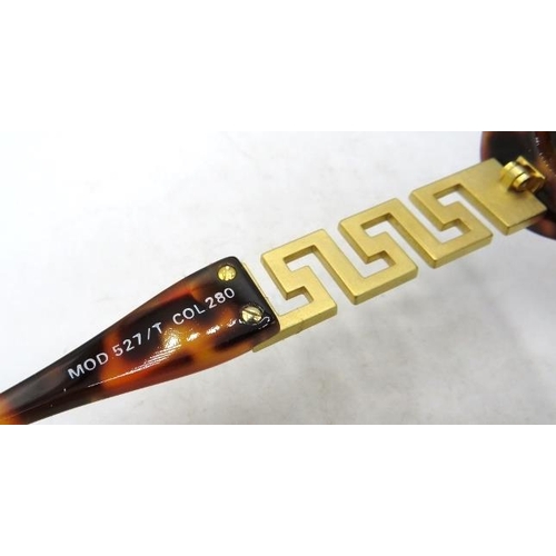 306 - A pair of Versace tortoiseshell effect sunglasses with gold coloured Greek key design pattern on the... 