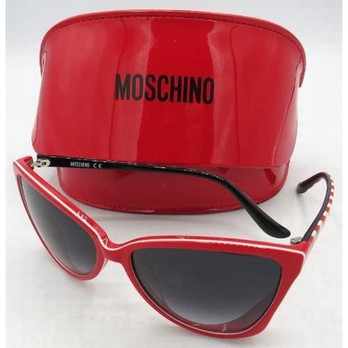 308 - A pair of Moschino red sunglasses with red and white stripped arms, cased.
Condition report: Good co... 