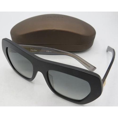 310 - A pair of Max Mara black sunglasses with gold coloured decoration on the transparent arms, cased.
Co... 