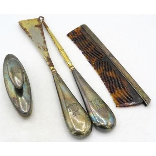 329 - A silver nail buffer, a silver backed comb and a pair of silver handles buttons hooks & shoe horn. A... 