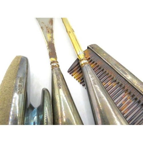 329 - A silver nail buffer, a silver backed comb and a pair of silver handles buttons hooks & shoe horn. A... 