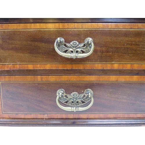 33 - An Edwardian nest of drawers. Mahogany with satin wood banding and foliate brass handles. (2 items) ... 